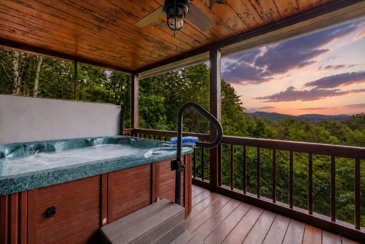 Soak in the layered mountain views from the private hot tub on the screened-in main-level deck, just steps from the living room and master suite for effortless indoor-outdoor relaxation.