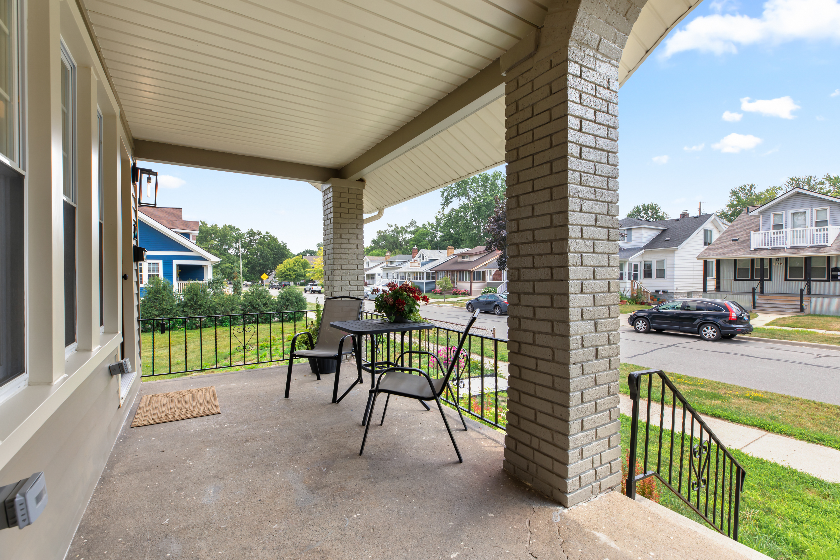 Relax on the covered front porch with seating for two and views of the charming neighborhood.