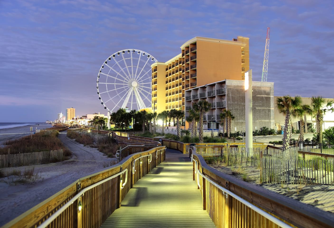 Scenic Boardwalk: Stroll along the lit pathway to breathtaking ocean views and the Ferris wheel!