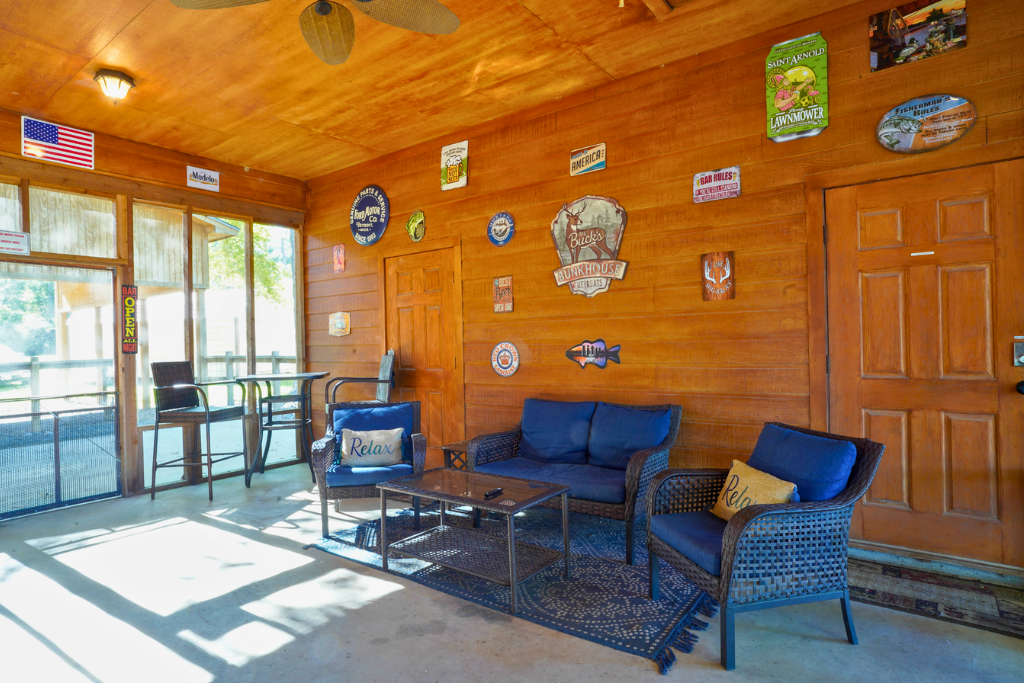 Screened-in patio with seating — bug-free lake breezes year-round.