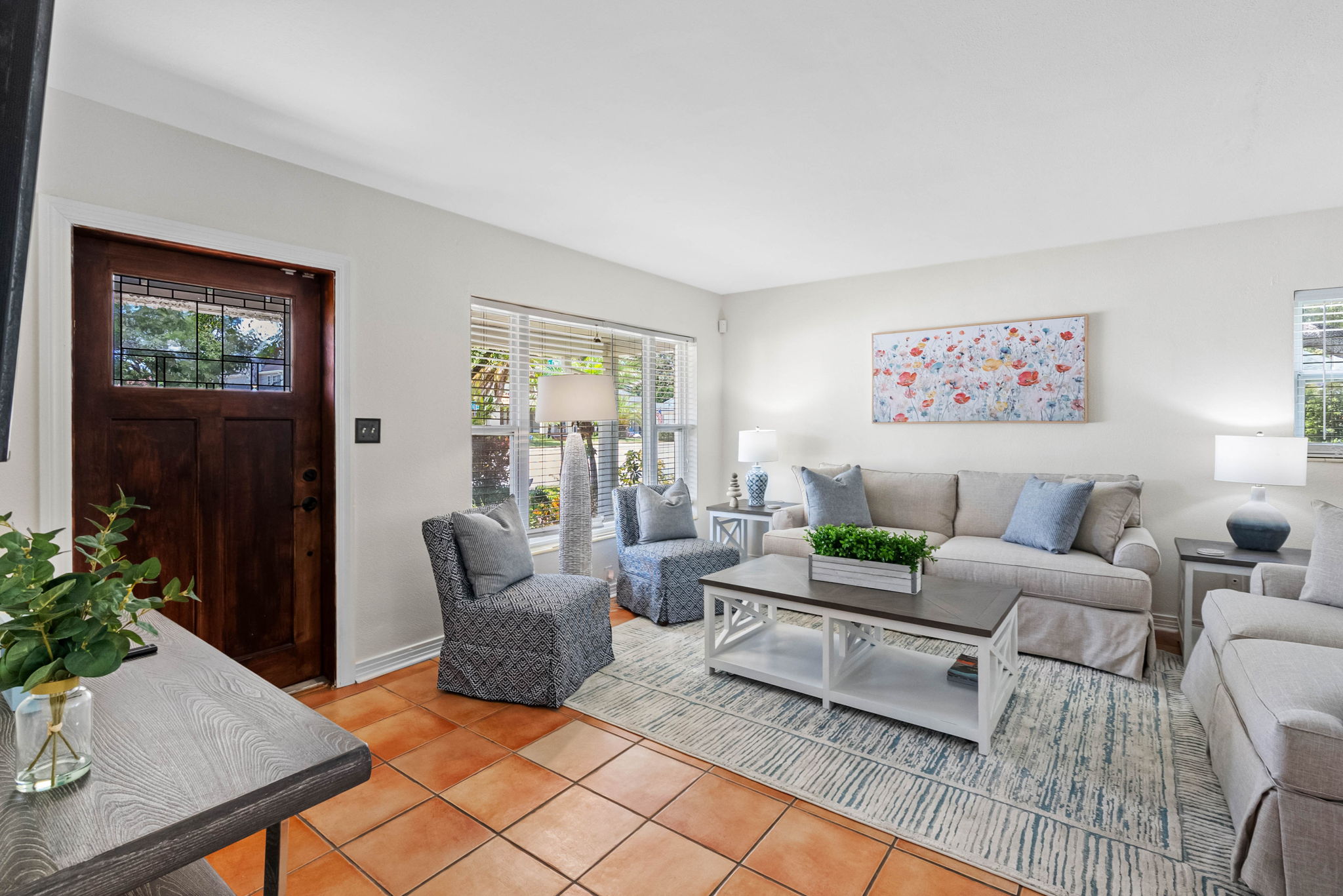 A bright, thoughtfully designed living room that blends cozy elegance with modern touches.