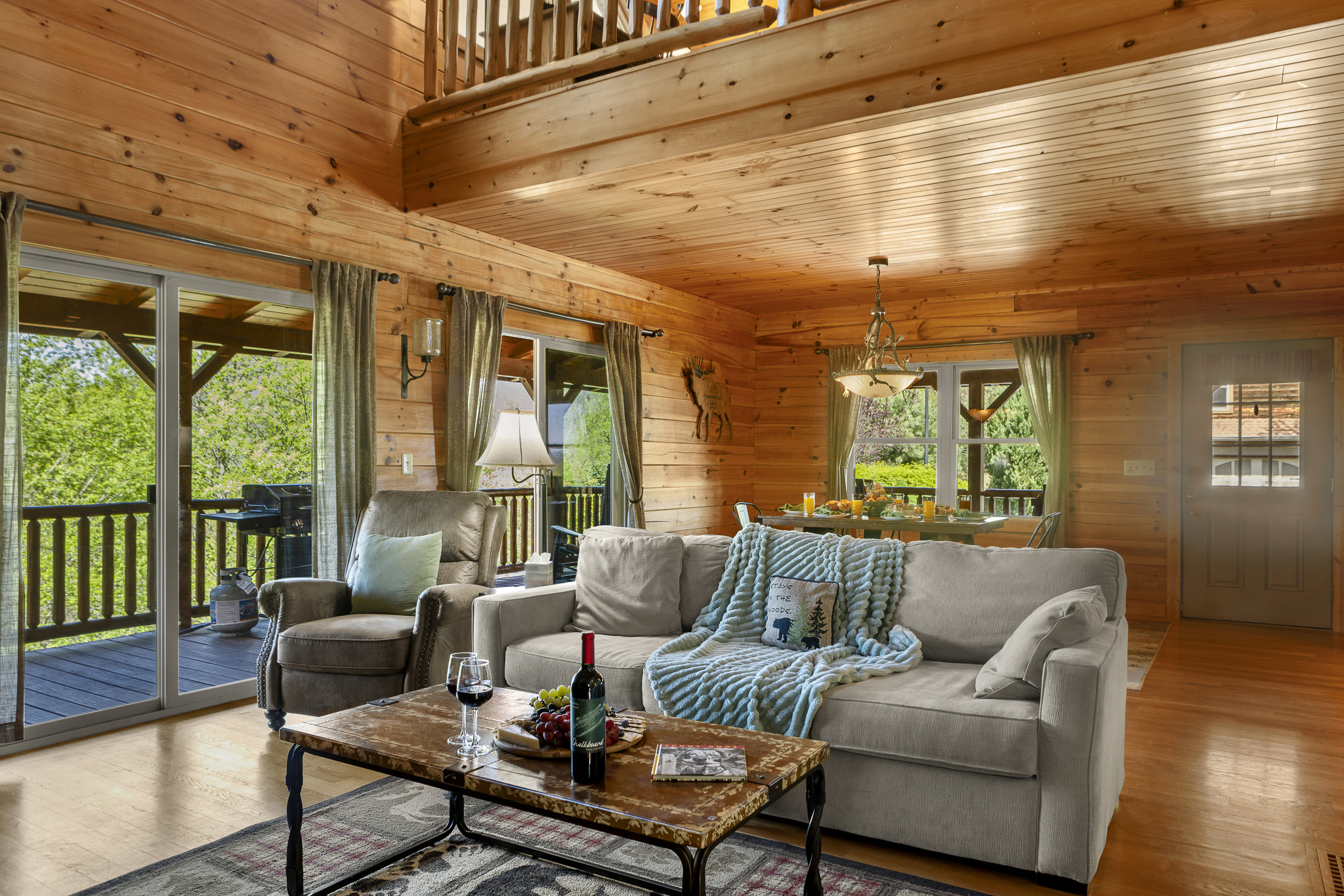 Living Room Retreat: Sunlight dances through large windows, inviting relaxation with stunning views.

