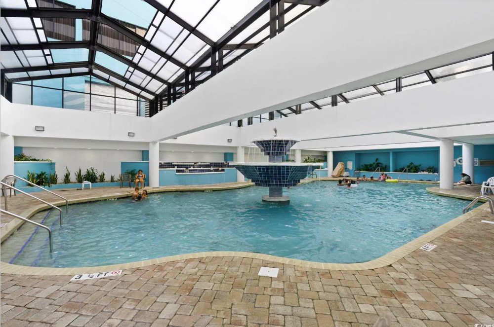 Behold the breathtaking view, where the azure waters of the pool seamlessly blend with the vast expanse of the ocean, creating a true seaside paradise.