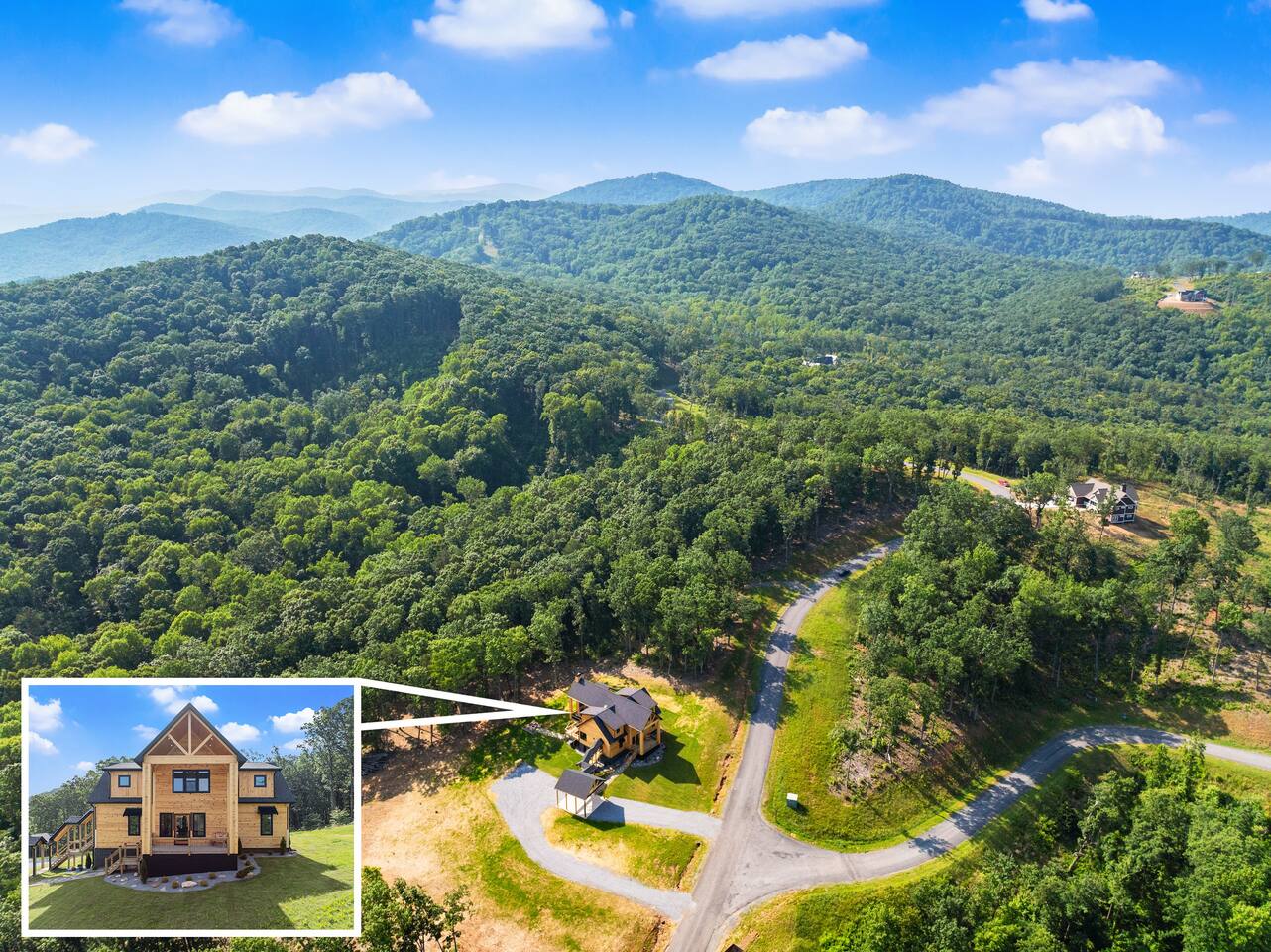 A stunning aerial view highlighting the lodge’s private setting surrounded by lush forest and mountain ridges.