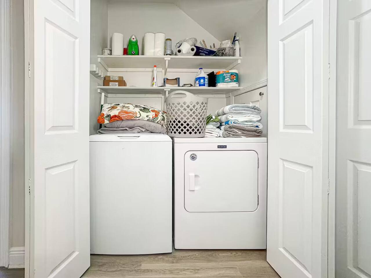 Convenient laundry area featuring a washer, dryer, and organized storage—perfect for longer stays.