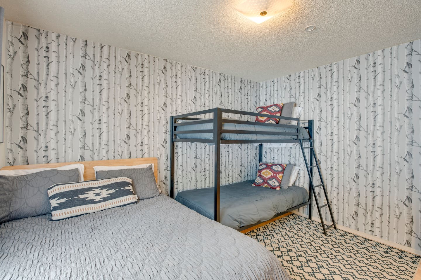 Downstairs bedroom with a bunk bed and a full size bed.