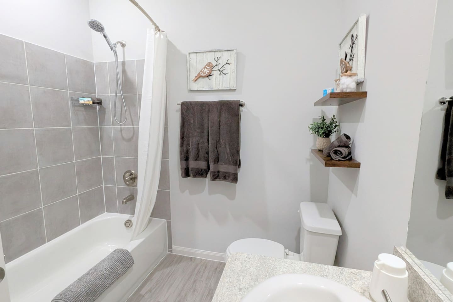 Bathroom has tub/shower combo and plenty of charm. 