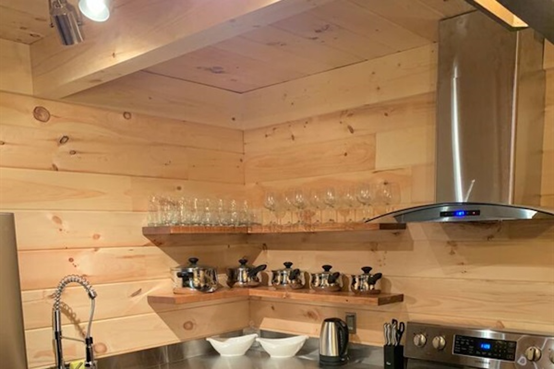 Kitchen workspace with stove, storage and range hood