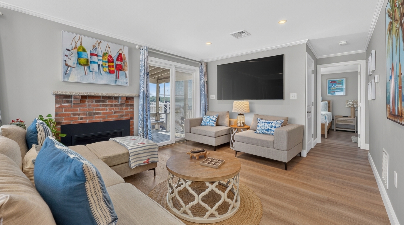 Comfortable seating, a large TV, fireplace, and plenty of natural light create the perfect gathering space.