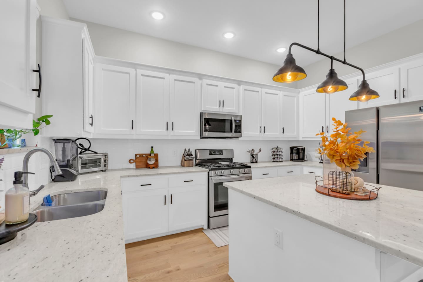 Fully equipped kitchen with stainless steel appliances and bold cabinetry.