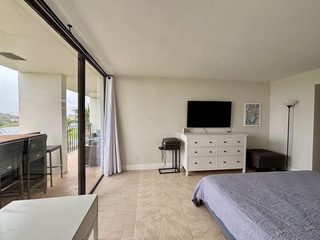 The bedroom also features a TV and workspace.