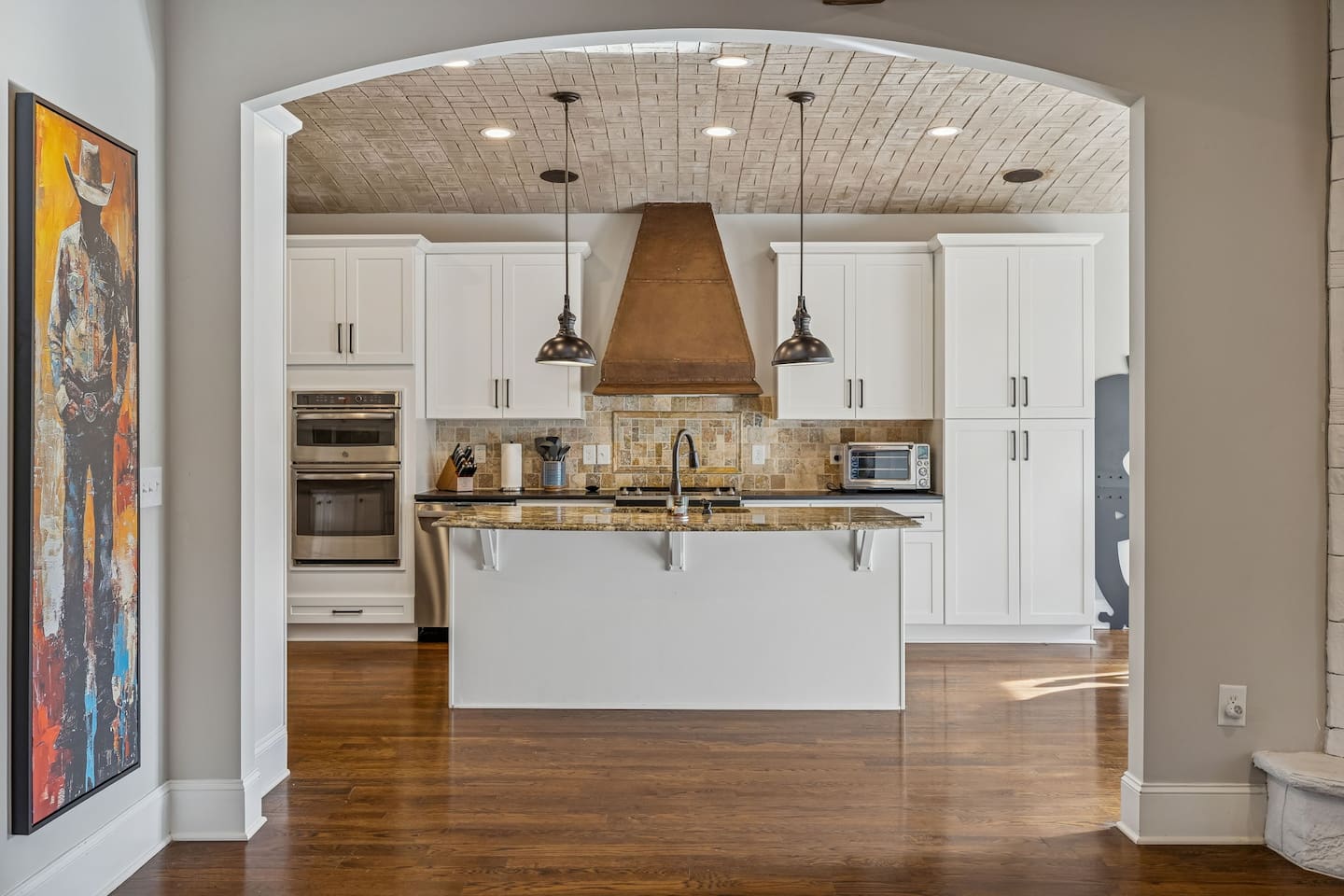 Entrance to Kitchen from Living Room with curved hand crafted ceiling