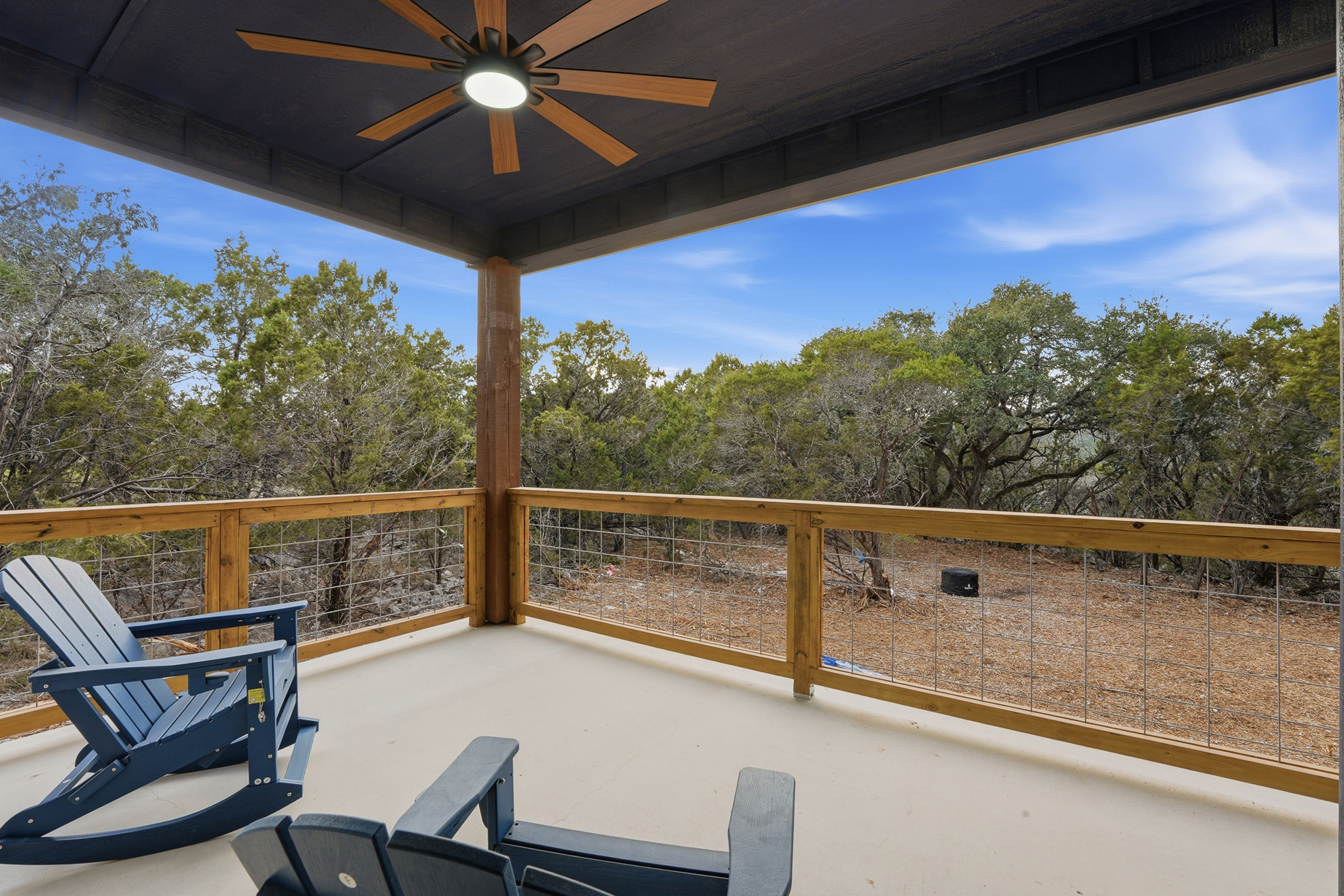 Rocking chairs off the Primary Suite  positioned at the more private end of the covered deck.