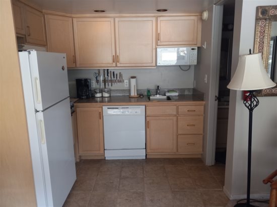 Kitchen area leading to bathroom.