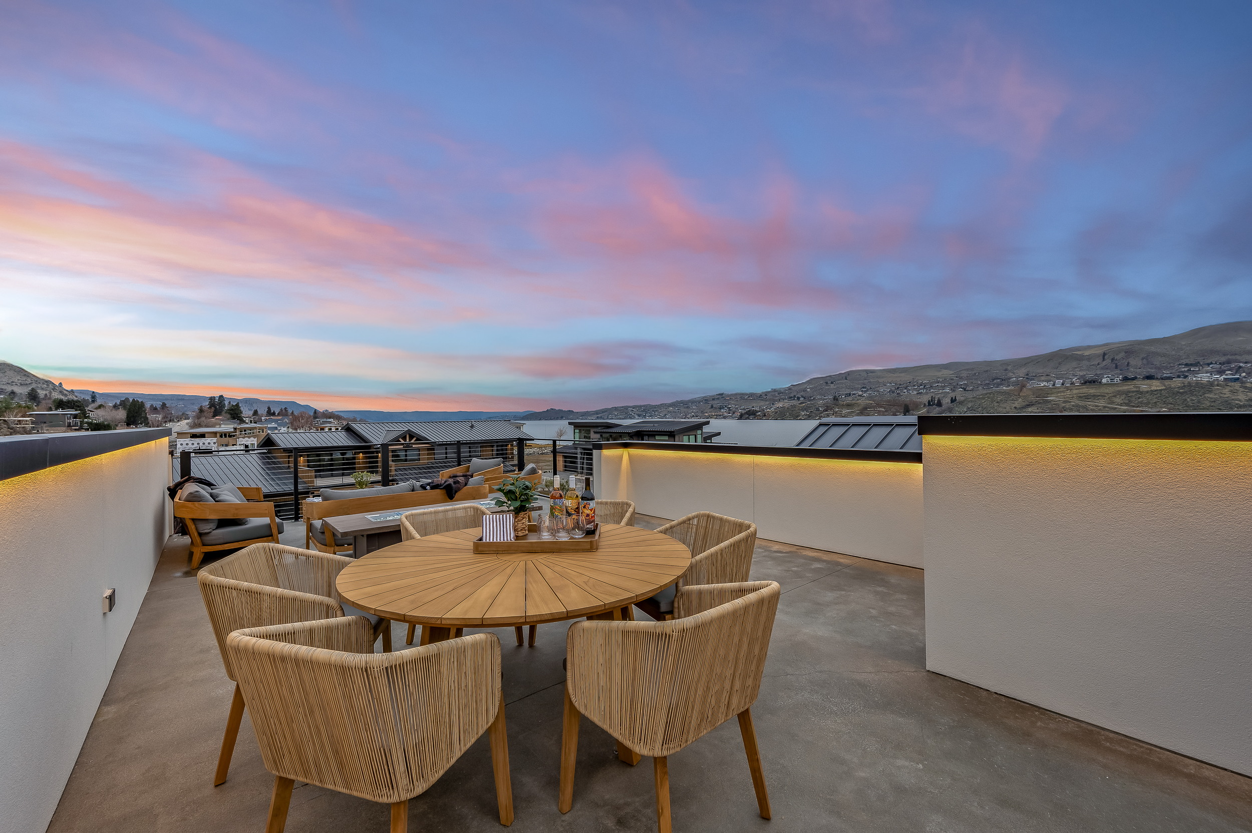 Rooftop deck with lounge seating, fire table and dining table