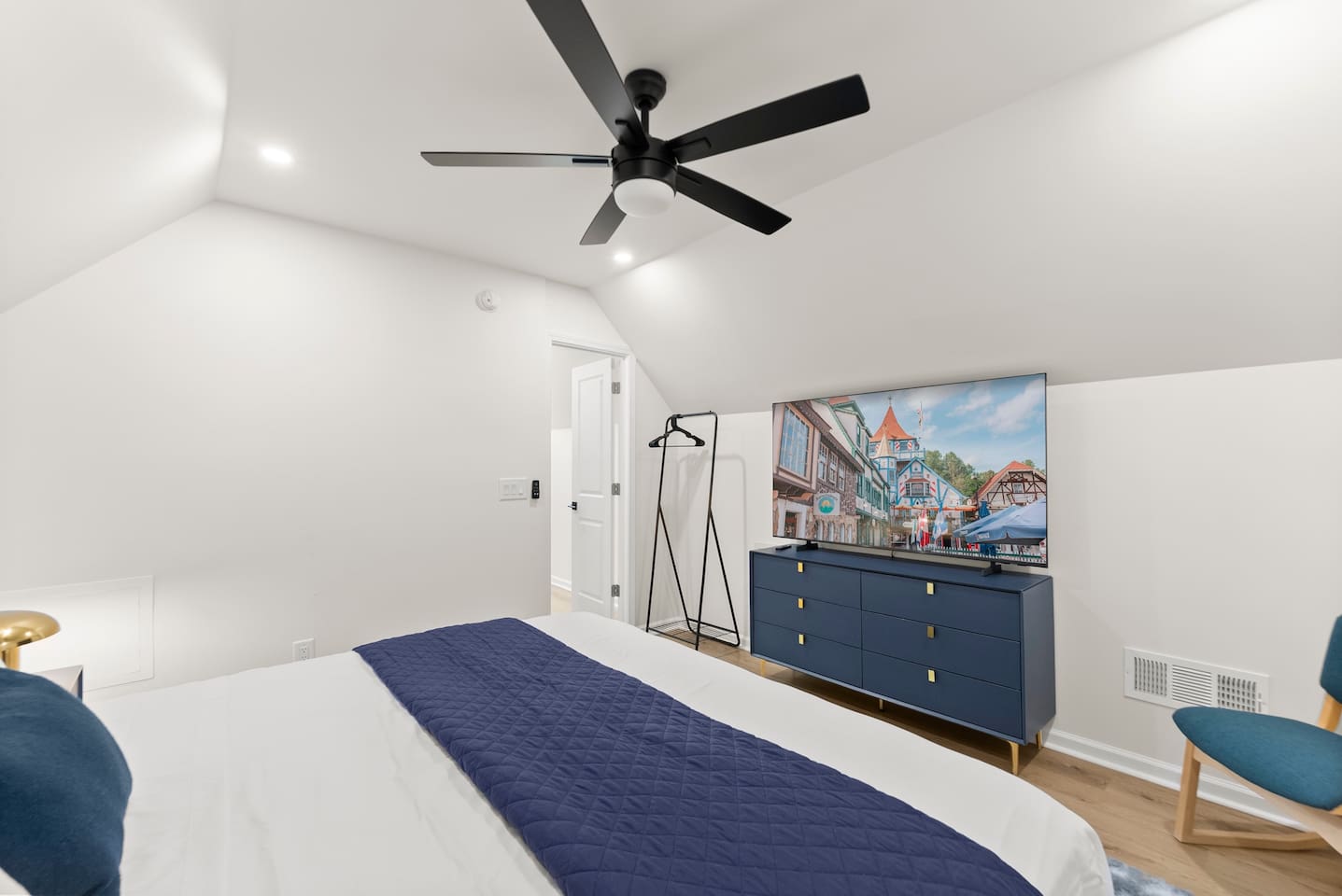 Upstairs king bedroom with a large TV—comfortable and perfect for relaxing.