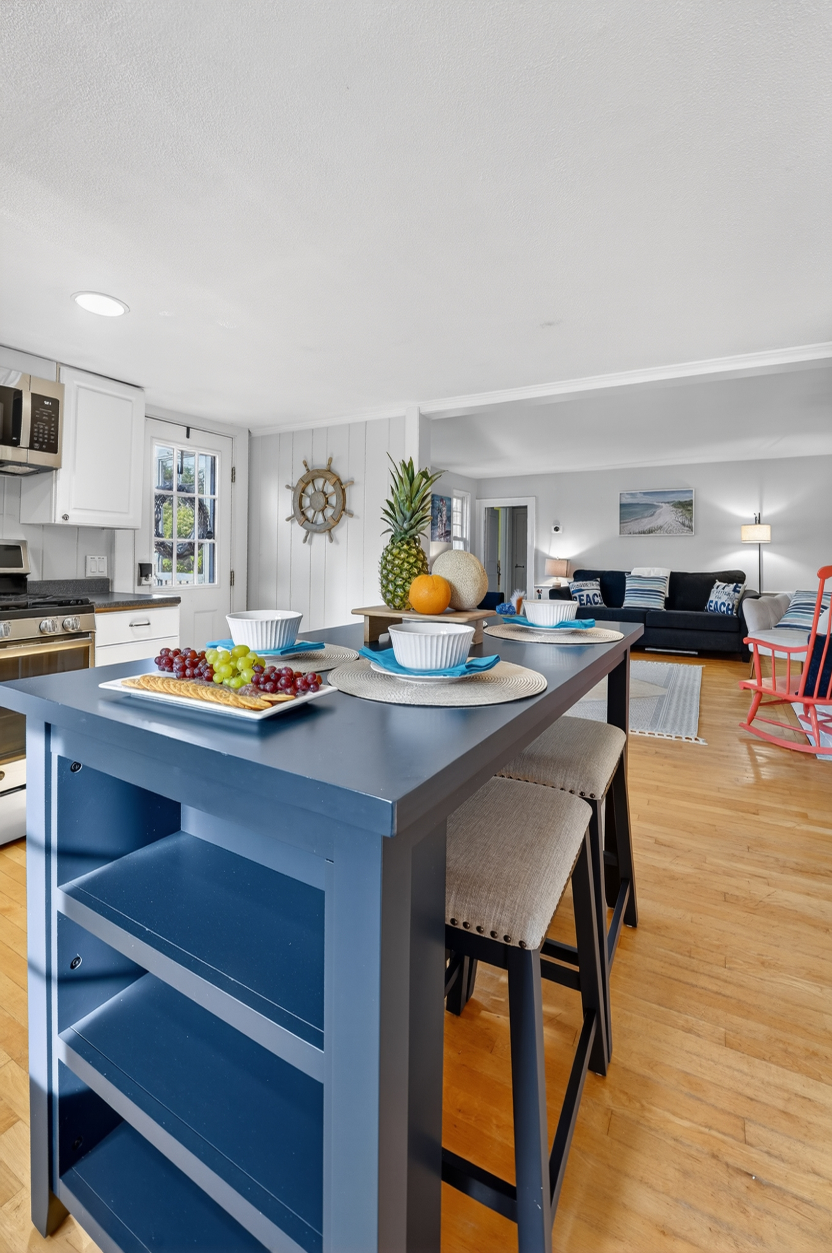 Large kitchen island with additional seating and open shelving—perfect for casual meals, morning coffee, or entertaining.
