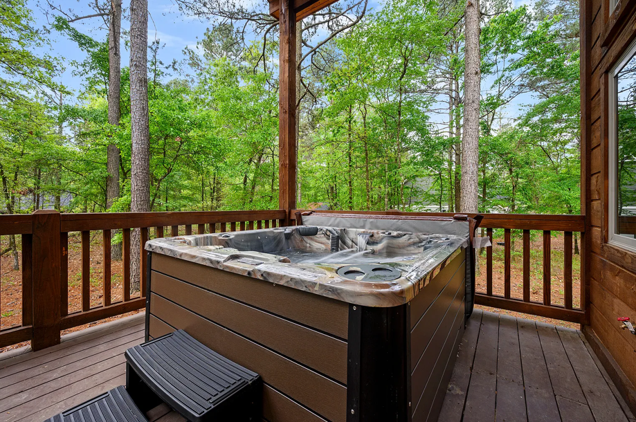 Private hot tub deck surrounded by peaceful forest scenery