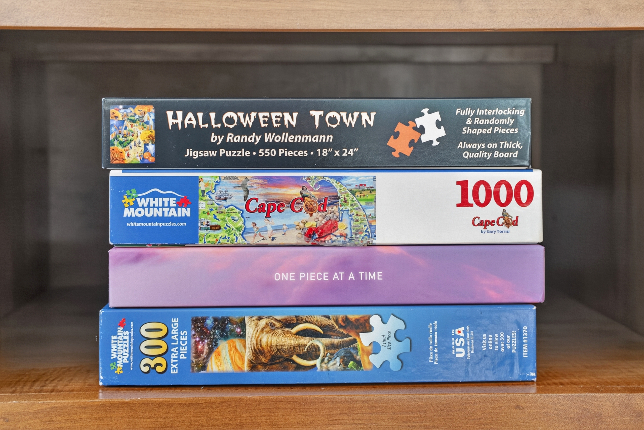 Collection of classic board games and puzzles neatly displayed on wooden shelving, perfect for cozy family game nights and indoor entertainment.