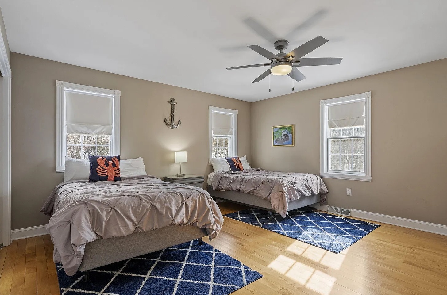 Bright and spacious bedroom with two double beds, dual closets, TV, and Desk/chair.