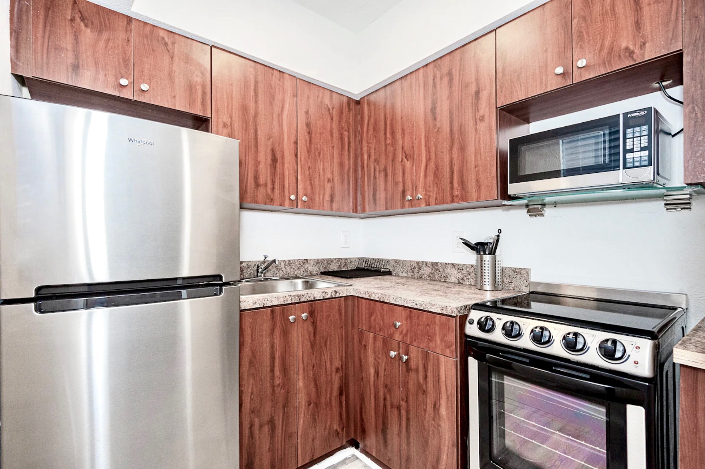 Kitchen with stainless steel appliances. 2m video tour includes open cabinets to show supplies.