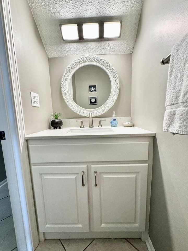 Bathroom Retreat: Bright mirror and sleek fixtures create a refreshing space to unwind!