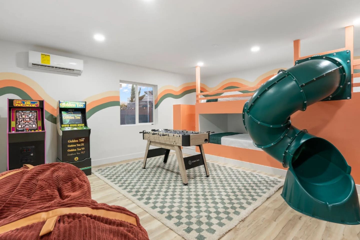 A dedicated game room brings the fun indoors too, with a slide, bunk beds, foosball, and classic arcade cabinets all in one colorful space.