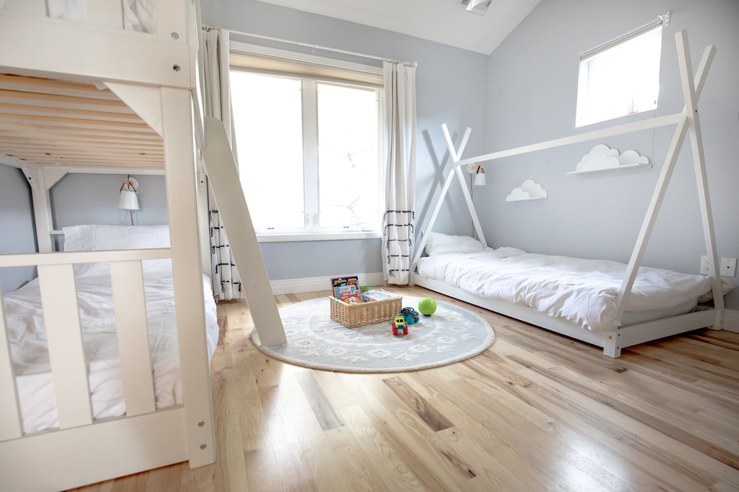 Designed for families, this whimsical kids’ room offers a unique bunk bed, an extra single bed, and a light-filled space that’s both cozy and inviting