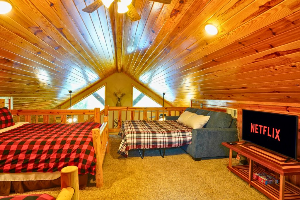 Loft sleeping area with 2 full beds + sleeper sofa — flexible sleeping for larger groups.