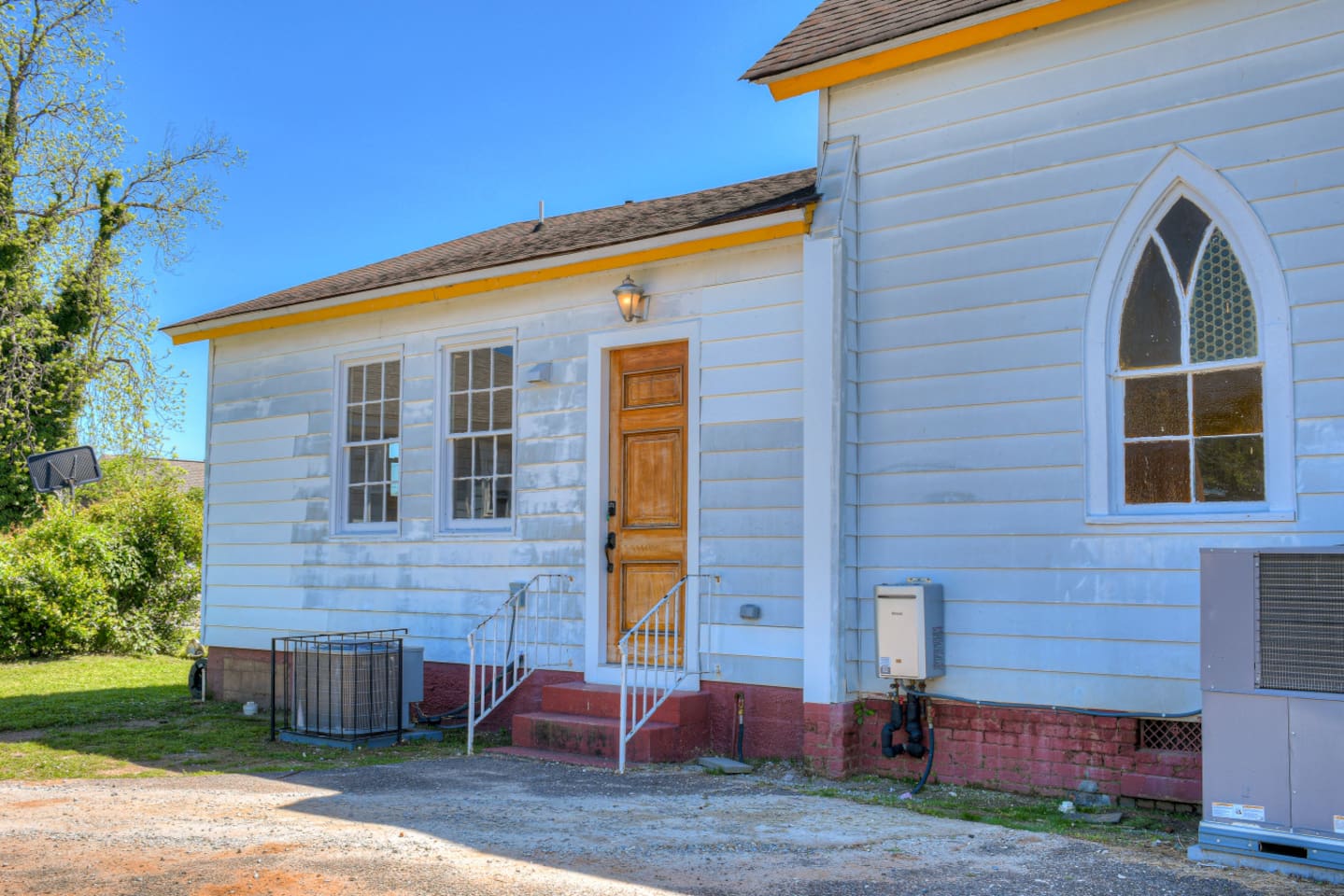 Rear view of property showcasing original siding.