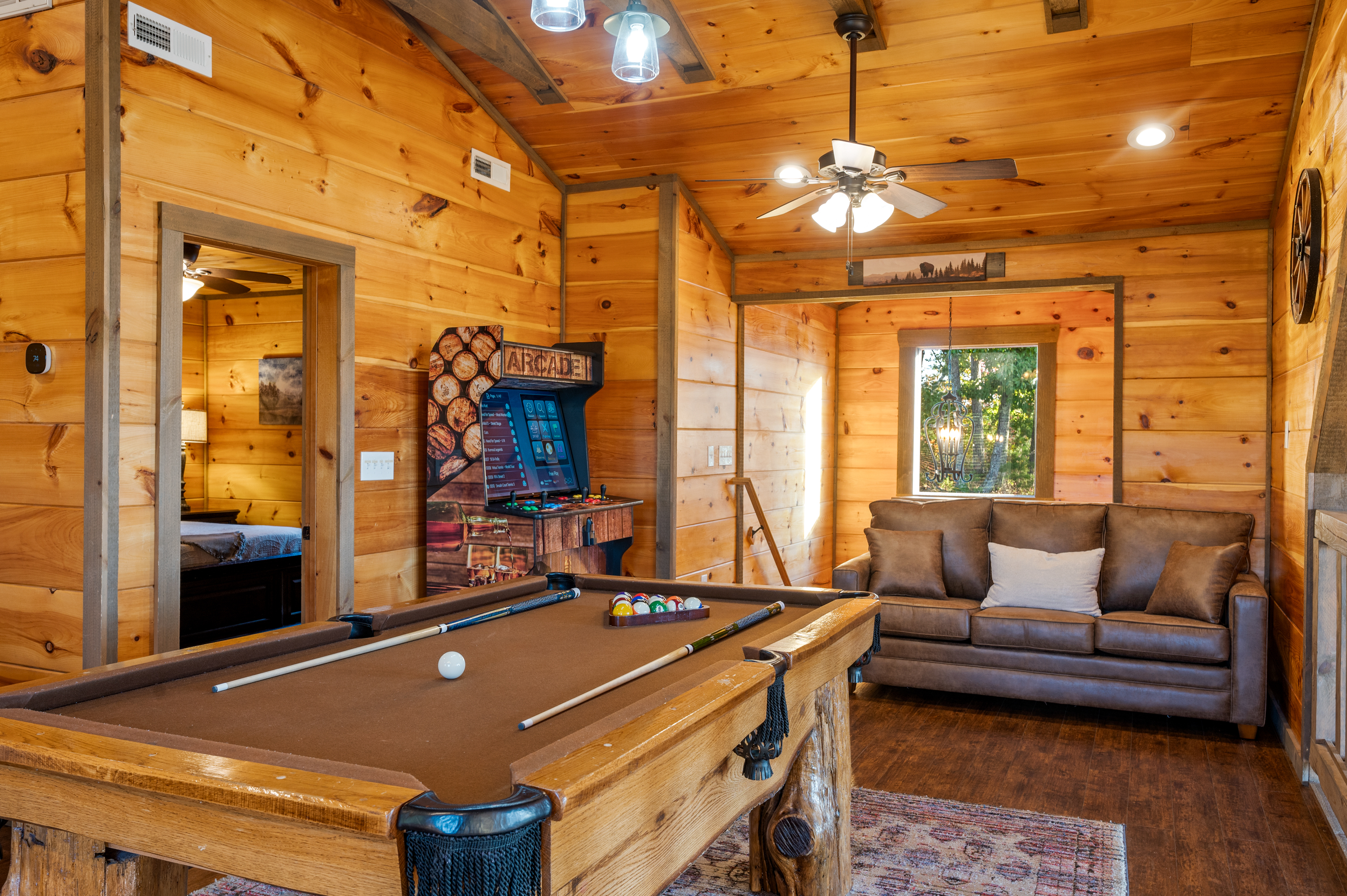 A better view of the pool table, GIANT arcade, and sleeper sofa in the loft.
