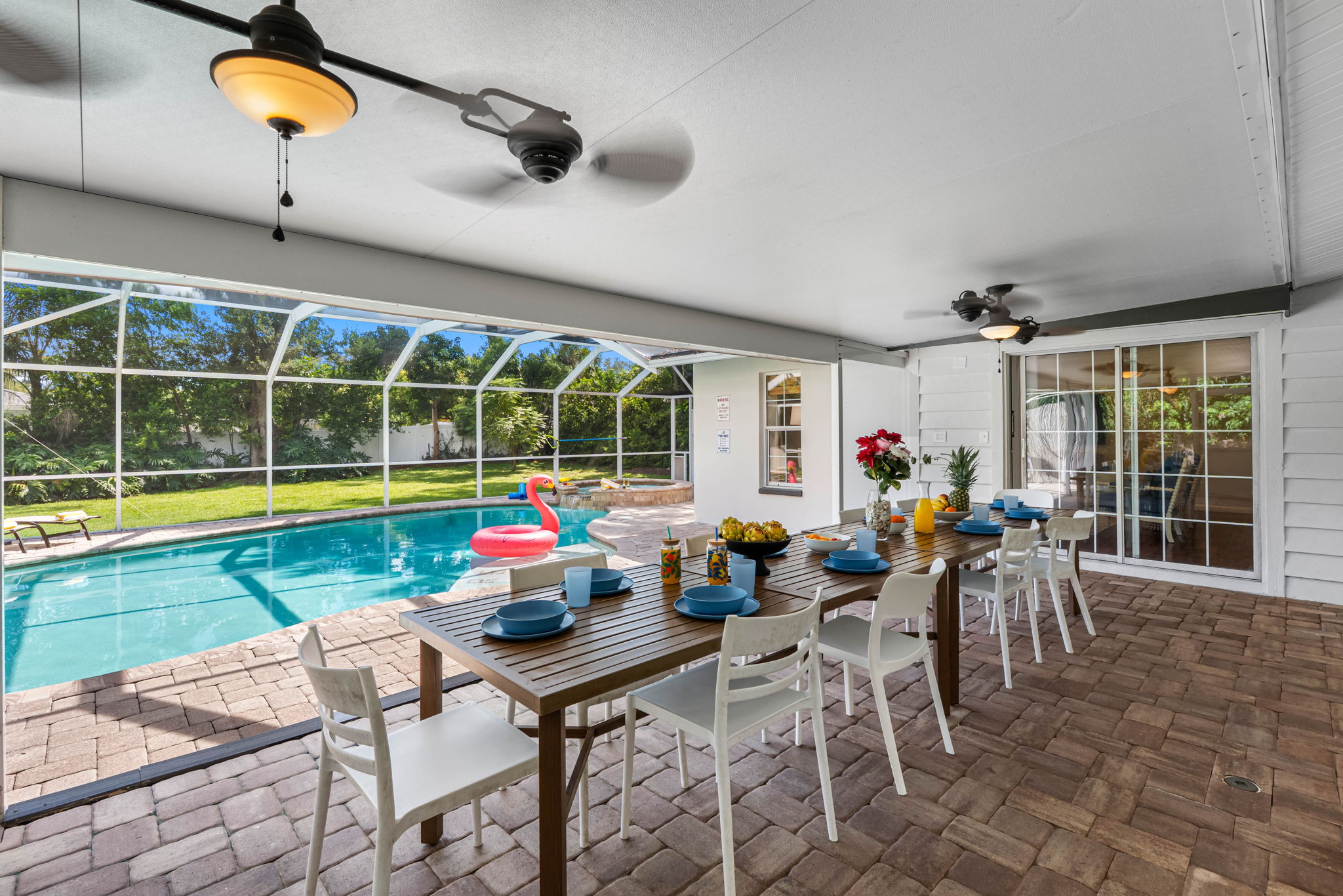 Enjoy year-round relaxation in this screened patio featuring a crystal-clear pool, lounge chairs, and space for family gatherings.