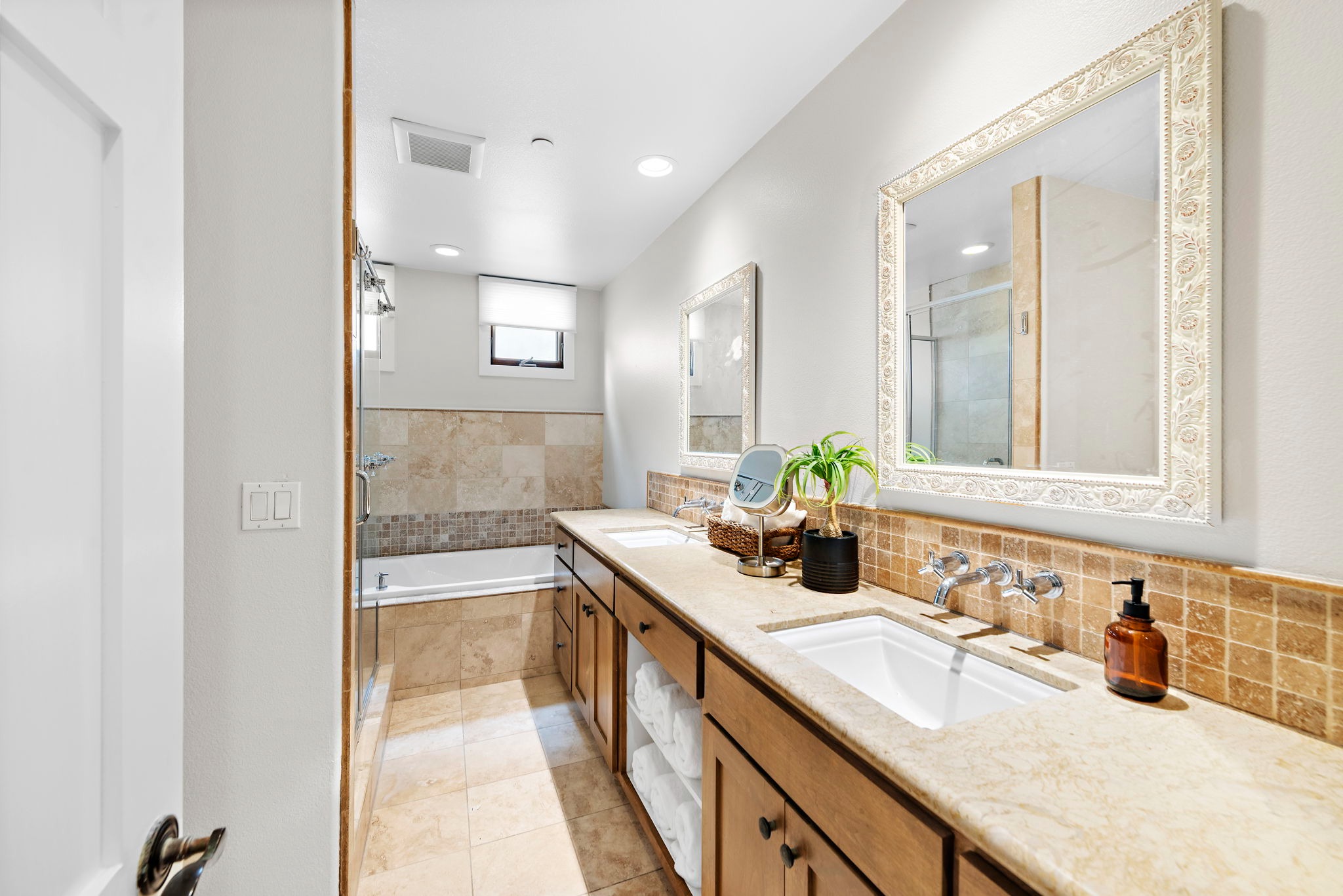 The spa-like remodeled bathroom has twin sinks, a soaking tub, a music system, and a shower with excellent water pressure. 