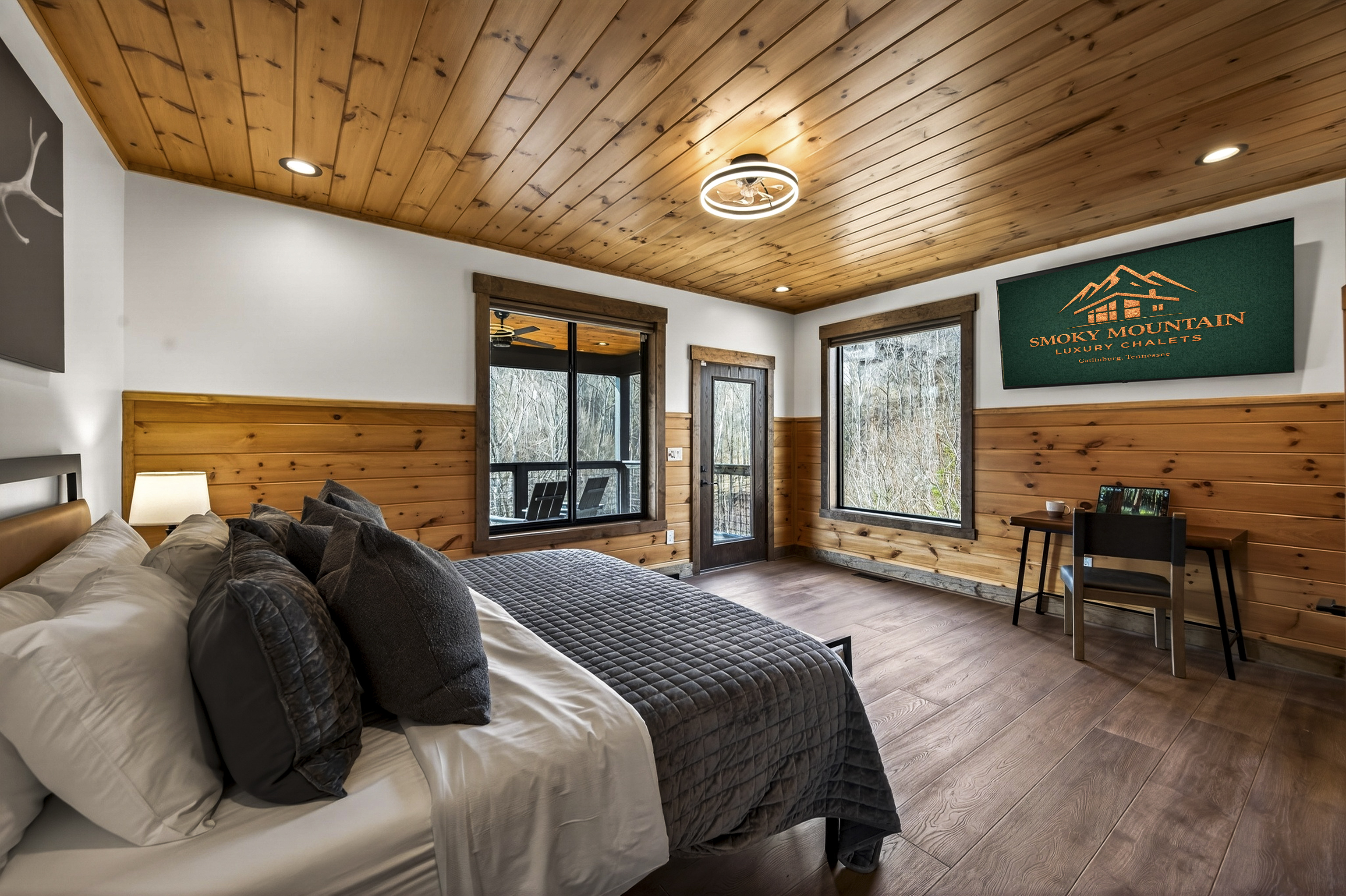 Relax in the spacious king bedroom with a large TV, dedicated desk workspace & direct deck access. Unwind in the en-suite bathroom featuring a walk-in shower with a natural river rock floor, bringing  the Smoky Mountains indoors for a spa retreat.