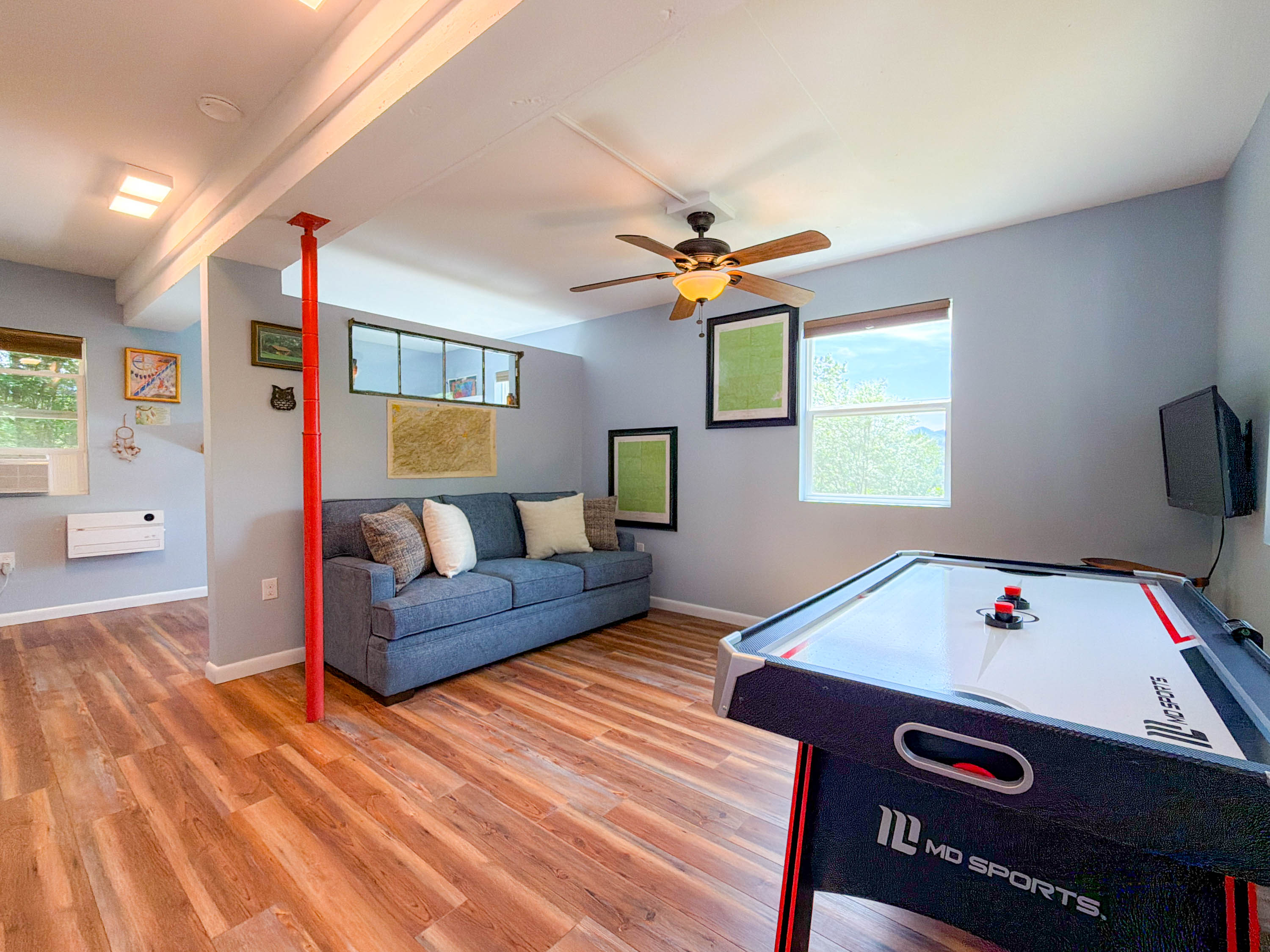 basement game room featuring an air hockey table, Smart TV, sitting area.