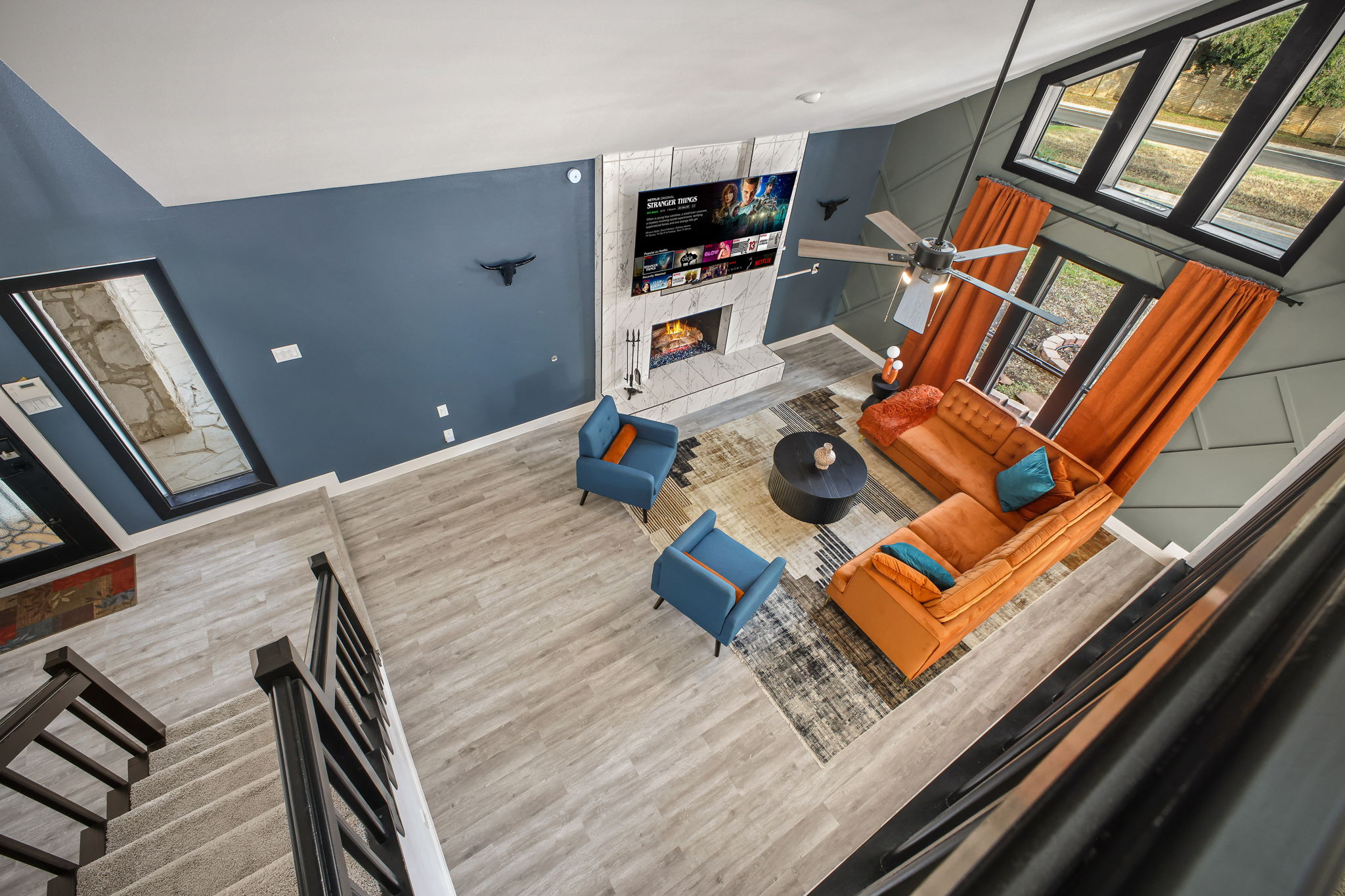 Vibrant living room with bold Southwest design and soaring ceilings. Please note: The living room fireplace is decorative only. For a real fire, enjoy the cozy outdoor fire pit!