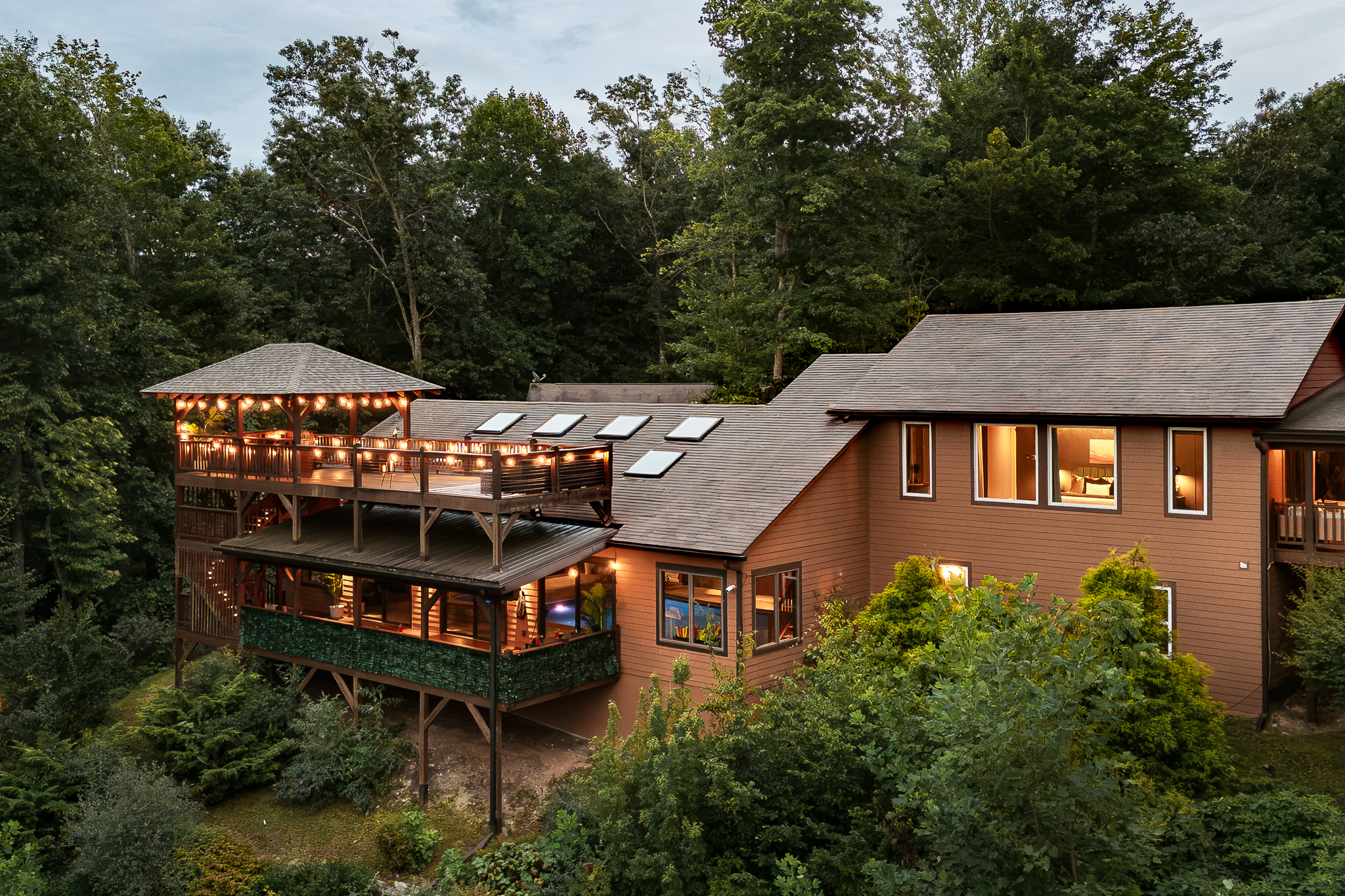 {Resort Exterior} Canopy Club glows at sunset, tucked into the mountains with layered decks, complete privacy, and sweeping Blue Ridge views.