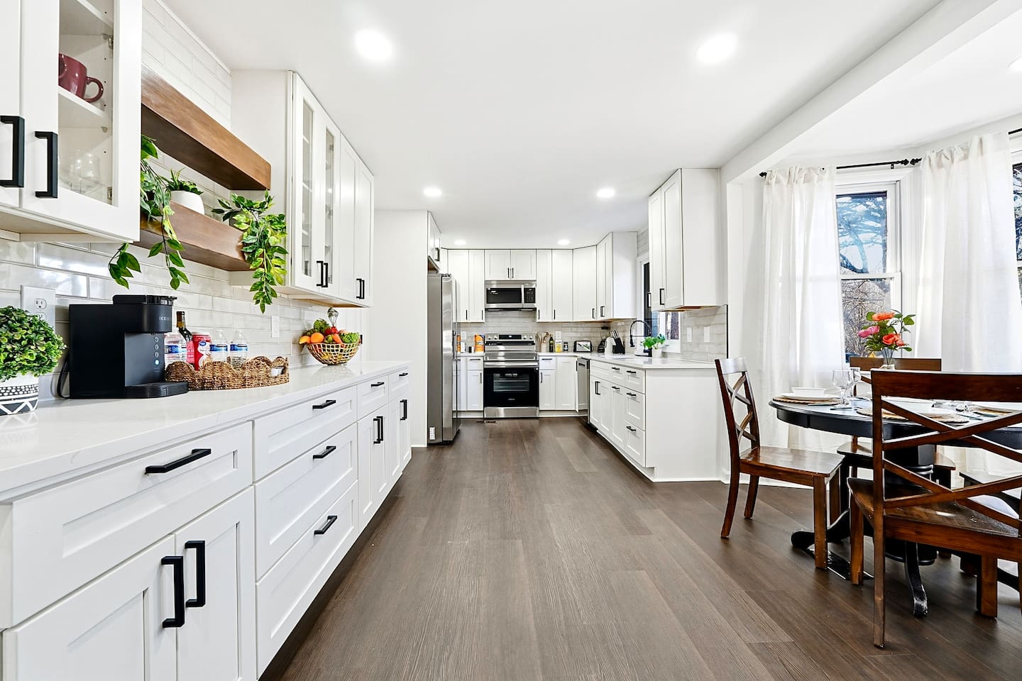 Bright white kitchen with a sleek, extended layout and ample counter space. The long layout offers plenty of countertop space, perfect for cooking, prepping, and everyday meals. Fully stocked with everything you need for a comfortable stay!
