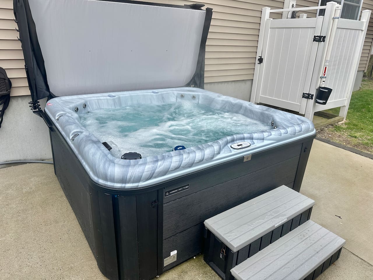 Enjoy a relaxing soak in the bubbling hot tub after a day of adventure. This private outdoor amenity features easy-step access and is situated right next to a convenient outdoor shower for a quick rinse before or after a dip.