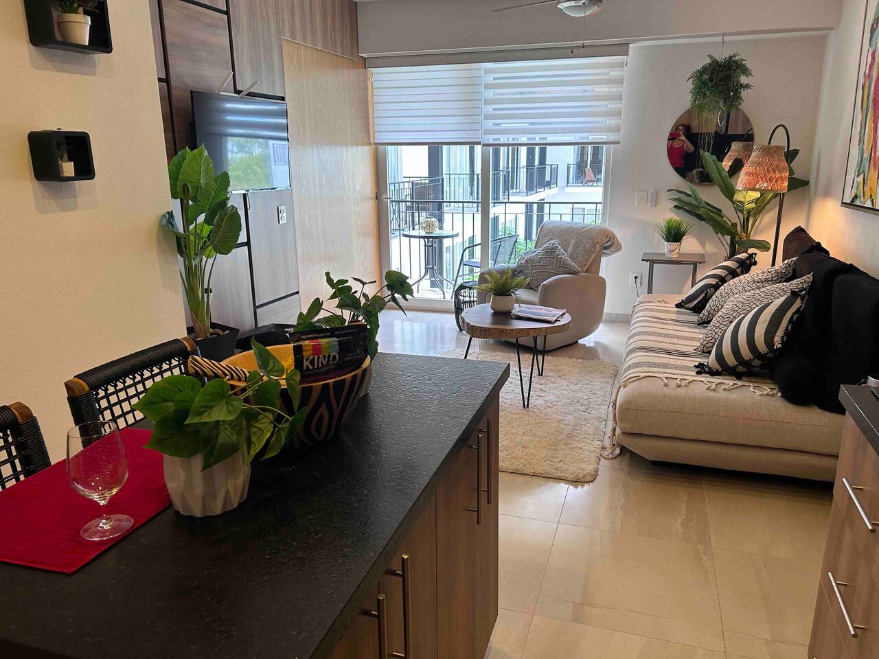 Living room looks out to the pool with a peek of the ocean