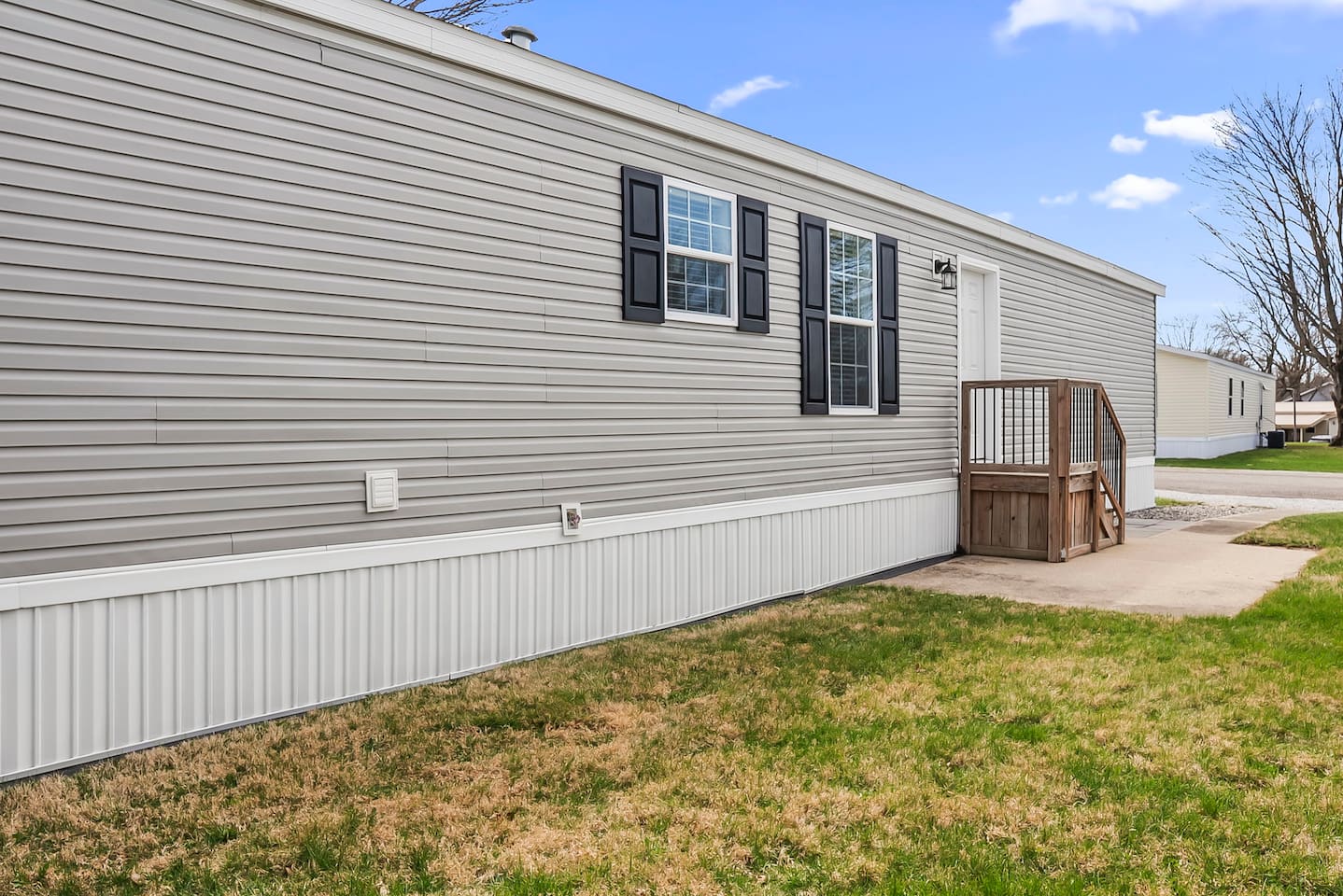 Spacious side yard with private entry steps and plenty of room to relax outdoors.