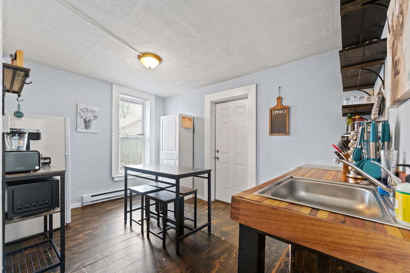 Stylish kitchen featuring a table for four and bar stools, creating a functional and inviting space for meals and gatherings.