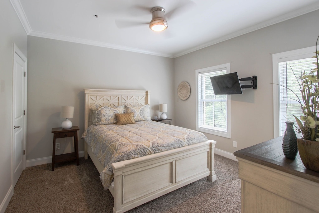 Bedroom 3 with queen bed and mounted tv