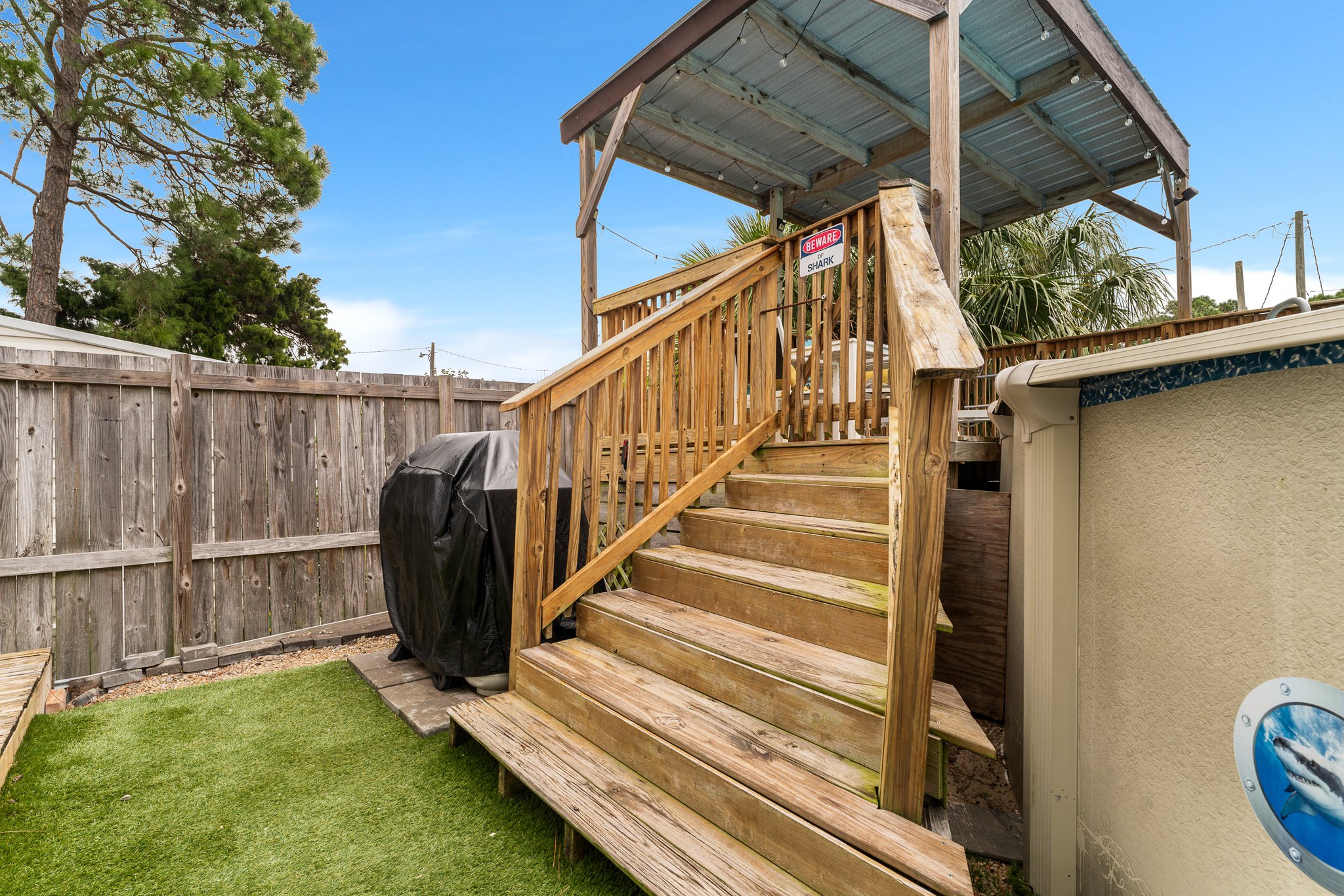 Covered hot tub, dartboard, sunroom interior