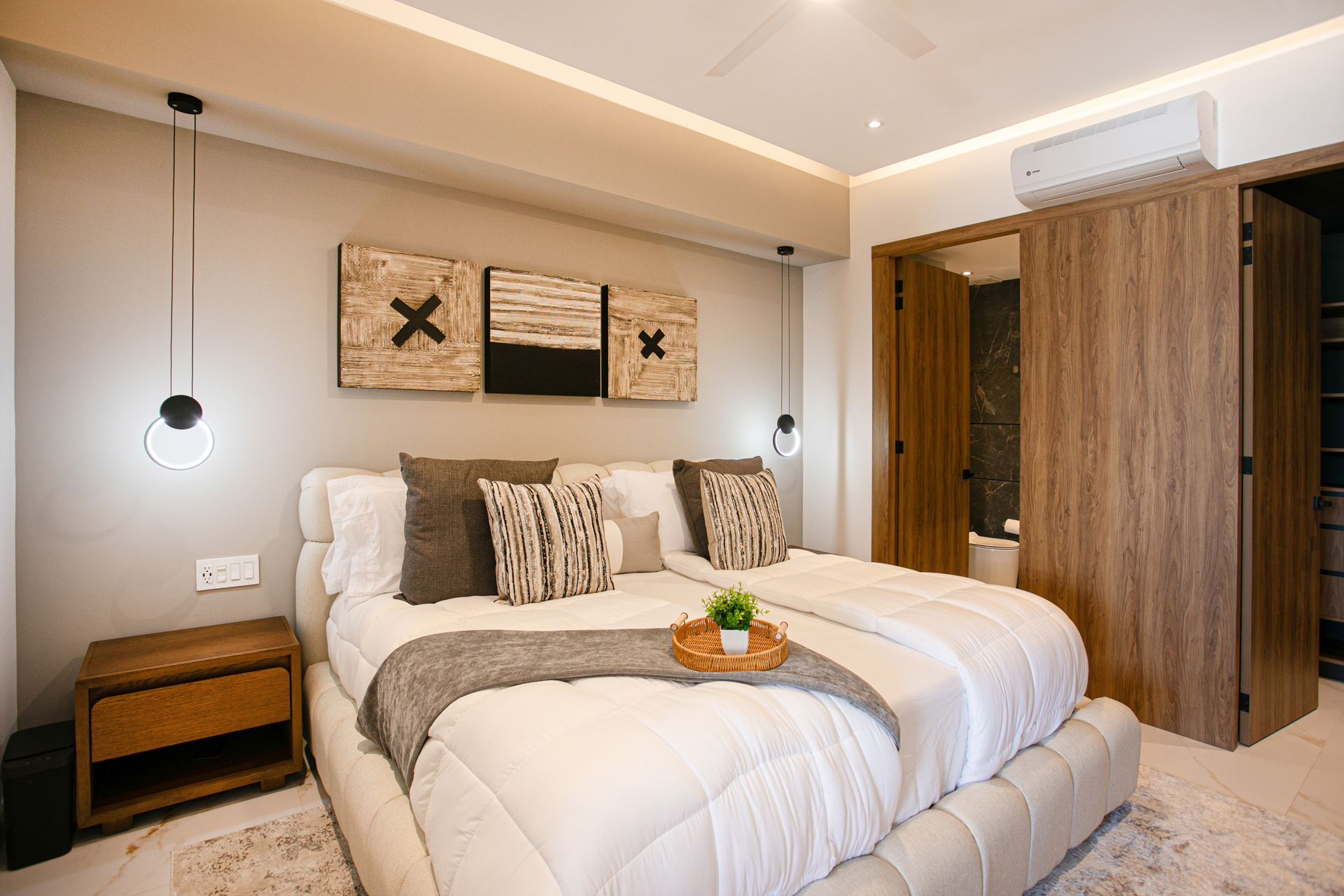 Retreat to the luxurious primary bedroom, designed with modern comfort, plush bedding, and blackout curtains for the perfect night’s sleep