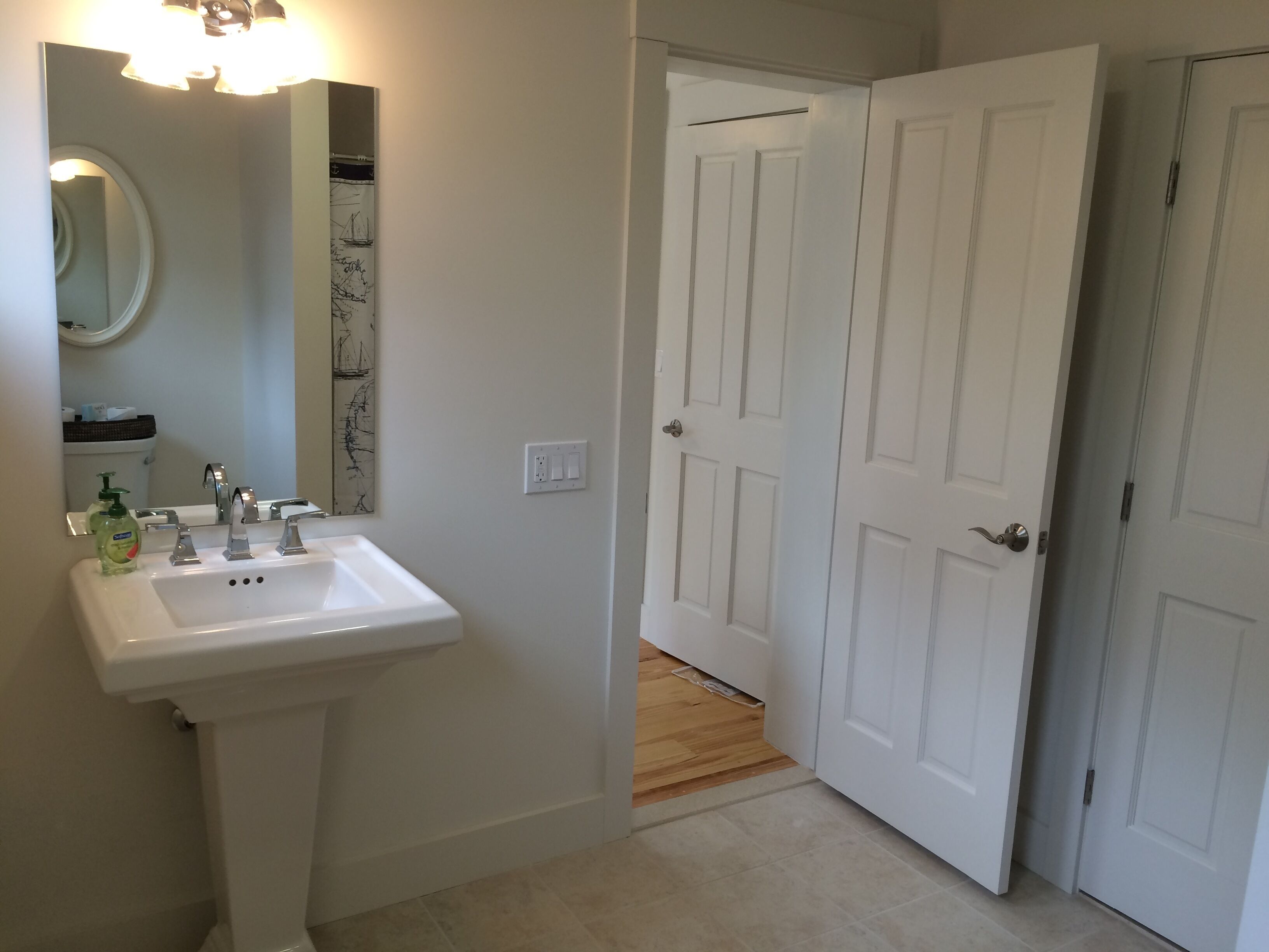Bathroom off of room with three twin beds.