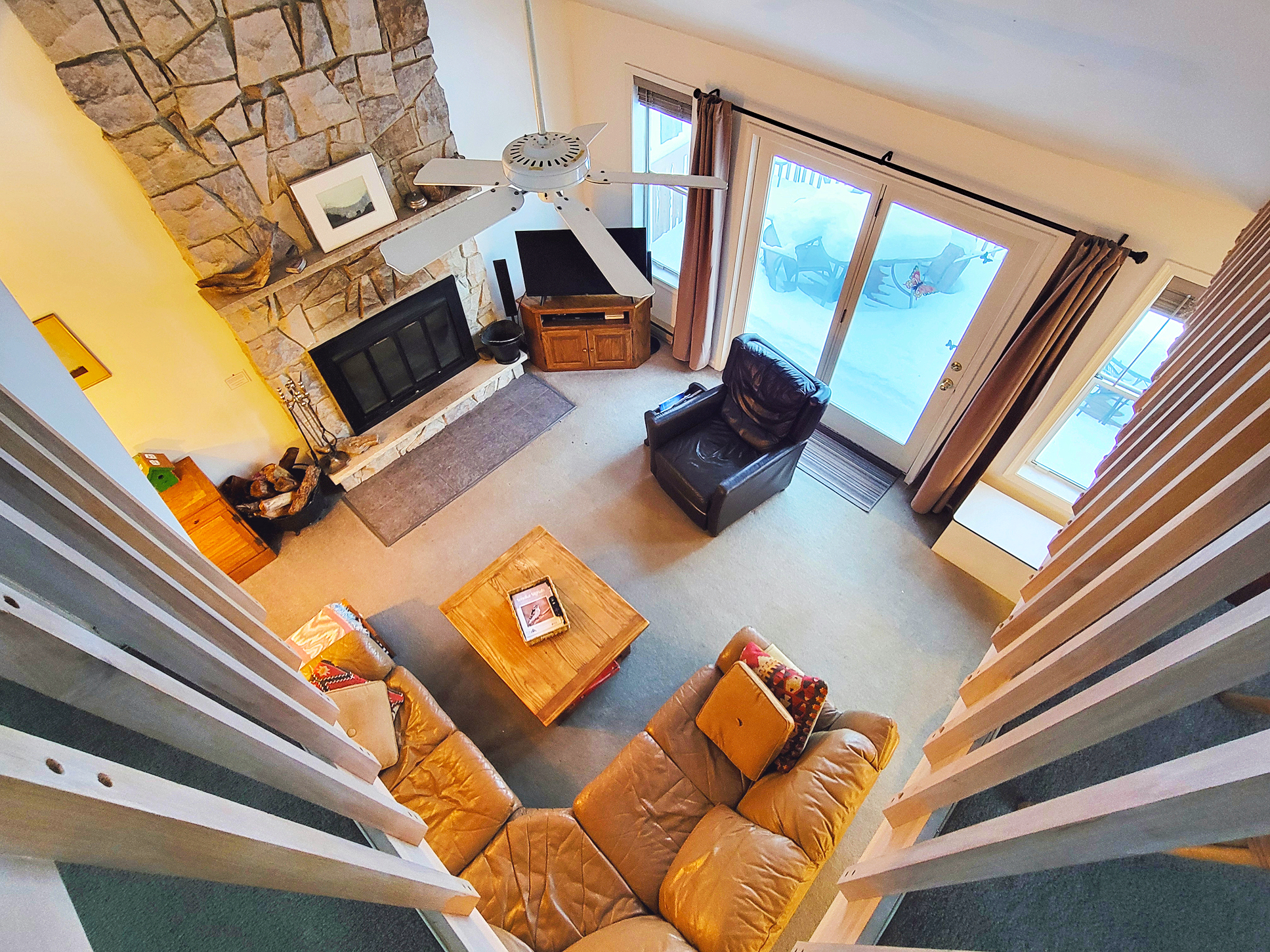 Sectional couch and TV next to fireplace in main living room