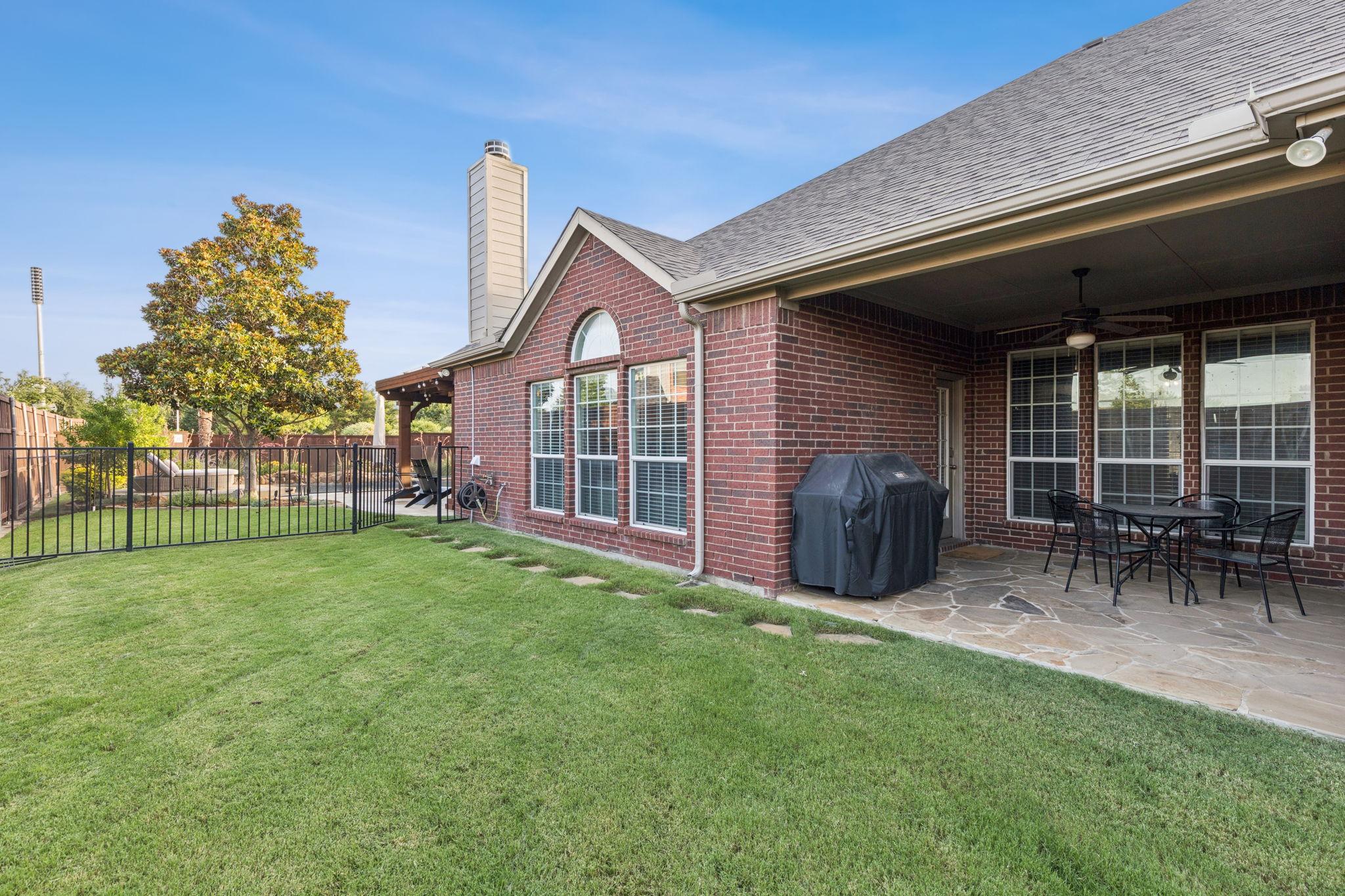 Covered patio with grill and grassy play space for your kids or furbabies.