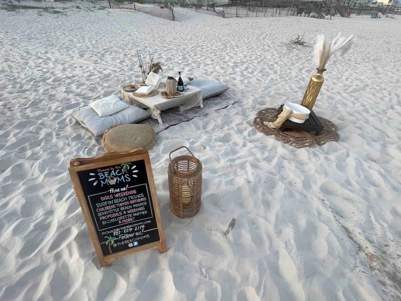 Want to picnic on the beach?  You can call and book with these ladies. Dreamy beach picnic setup for special celebrations with cozy vibes and ocean views.