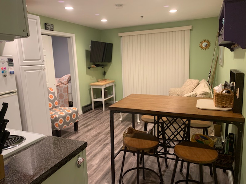 Living space opposite the kitchen area complete with flat screen tv and pull out sleeper sofa.